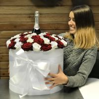Roses in hat box with a champagne